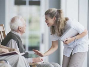caregiver patting elderly patient