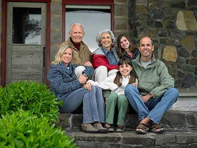 Family smiling with Alzheimer's grandparent