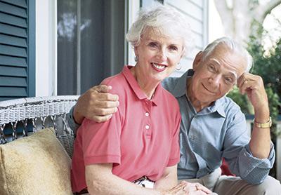 seniors sitting on wicker bench