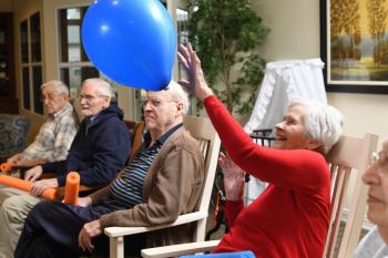 Elderly Woman Playing with Balloon