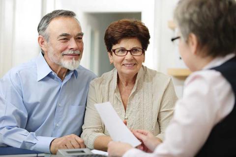 Couple talking with banker