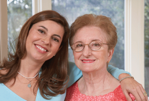 smiling elderly woman and daughter